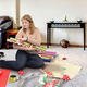 Illustration for article titled Mom Gathers Rolls Of Wrapping Paper Around Her To Stroke Softly